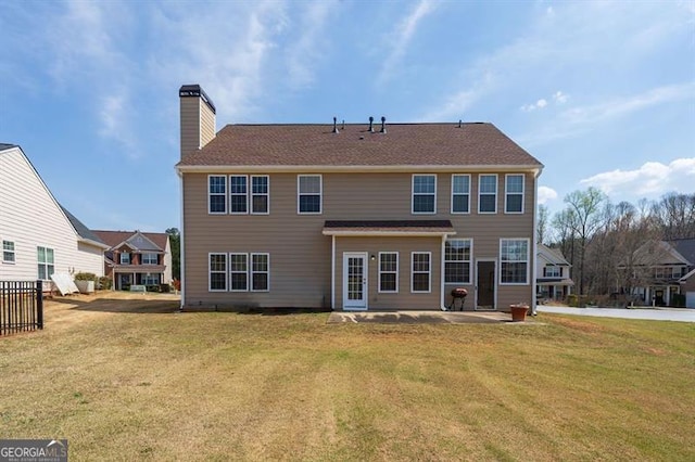 rear view of house featuring a yard and a patio