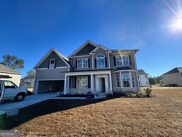 view of front of house with a garage and a front lawn