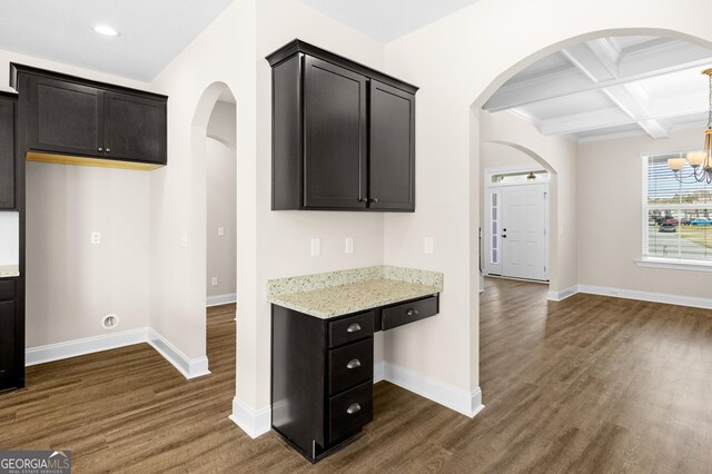 unfurnished living room with ceiling fan, a raised ceiling, and dark colored carpet