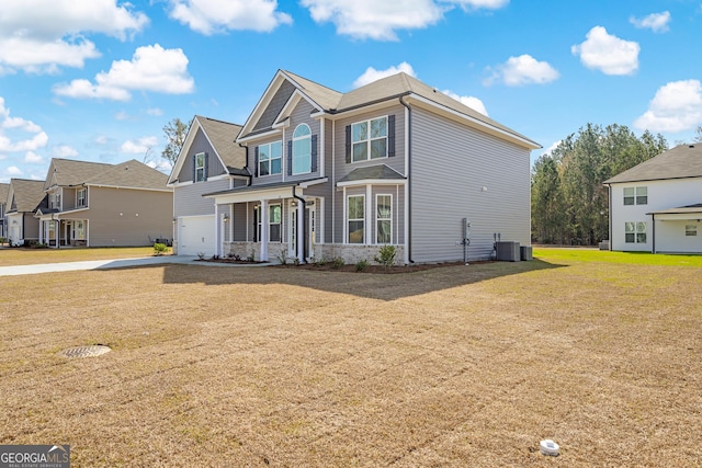 view of front of property with a front lawn, a residential view, central AC unit, a garage, and driveway