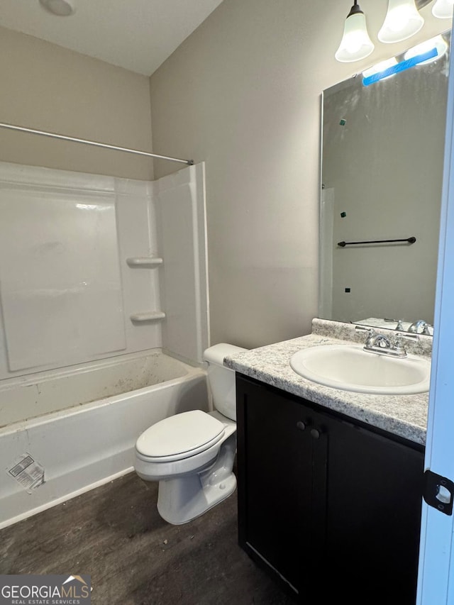 full bathroom featuring toilet, shower / bathtub combination, wood-type flooring, and vanity