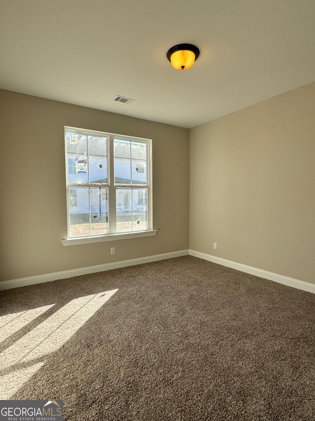 empty room featuring carpet flooring