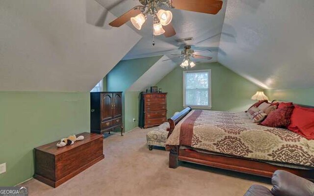 bedroom with lofted ceiling, light colored carpet, and ceiling fan