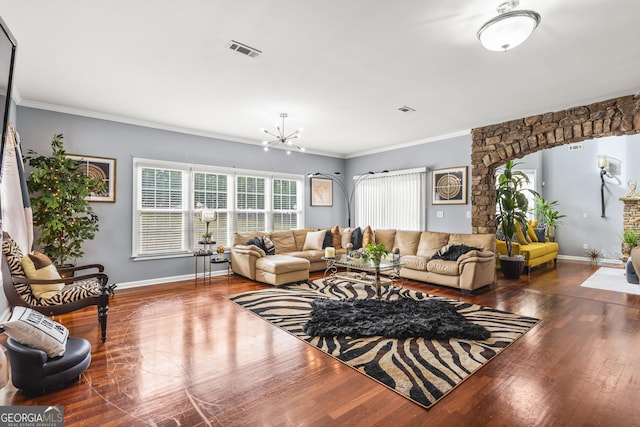 living room featuring a chandelier, hardwood / wood-style floors, and crown molding