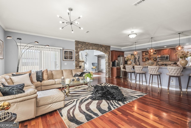 living room with an inviting chandelier, crown molding, and dark hardwood / wood-style floors