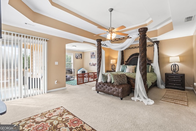 bedroom featuring a raised ceiling, access to exterior, ceiling fan, and carpet