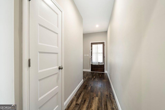 hallway with dark hardwood / wood-style flooring