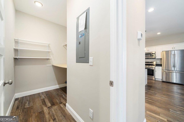 hall with electric panel and dark wood-type flooring