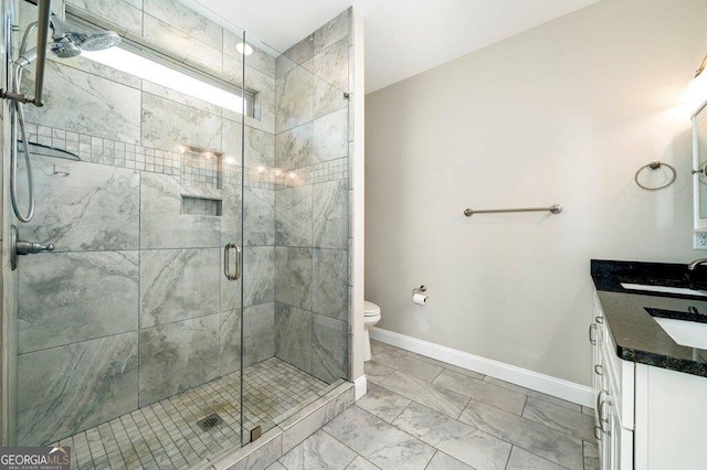 bathroom with toilet, an enclosed shower, and vanity