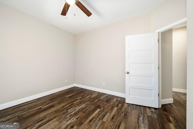 spare room featuring ceiling fan and dark hardwood / wood-style flooring