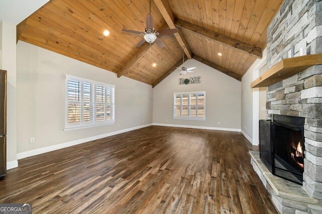 unfurnished living room with beamed ceiling, a fireplace, wood ceiling, and dark hardwood / wood-style floors