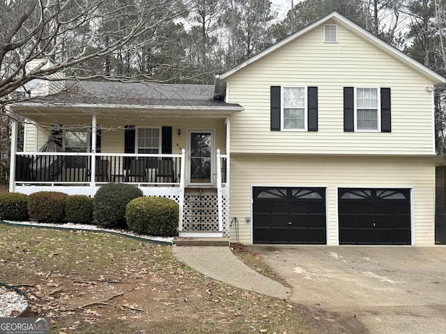 view of front of property featuring a garage and a porch