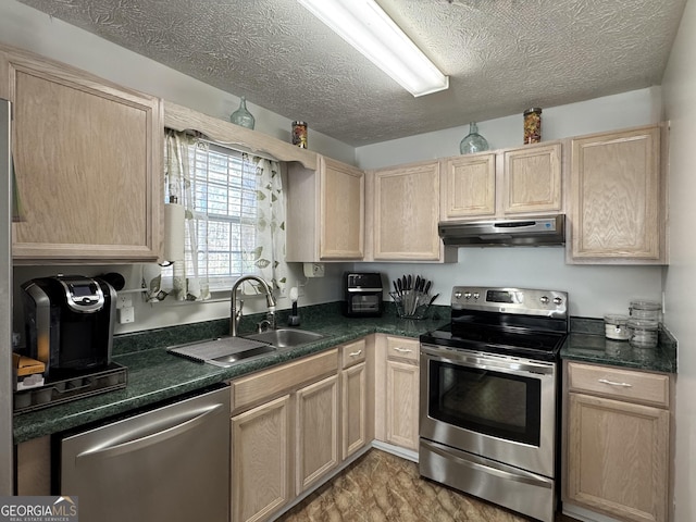 kitchen featuring light brown cabinetry, sink, and stainless steel appliances