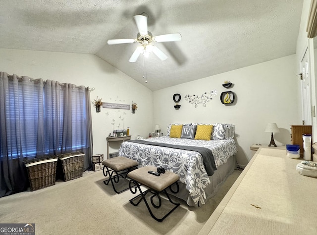 carpeted bedroom with lofted ceiling, a textured ceiling, and ceiling fan