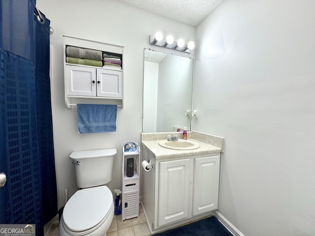 bathroom featuring vanity, a textured ceiling, and toilet