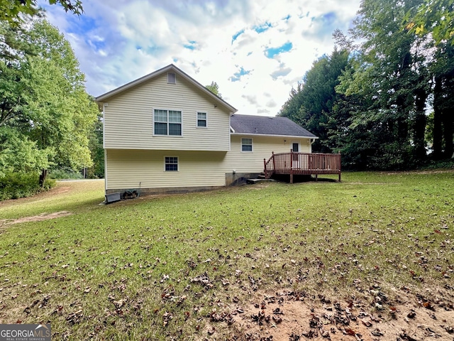 back of house featuring a deck and a lawn