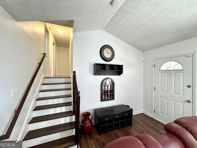 foyer with lofted ceiling and dark hardwood / wood-style flooring