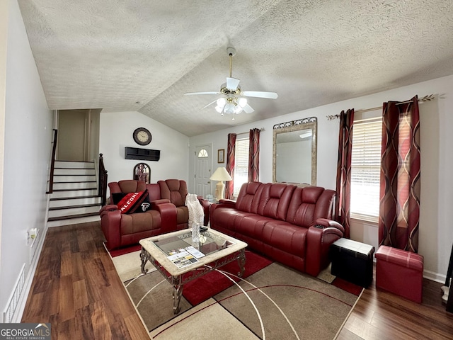 living room with hardwood / wood-style flooring, vaulted ceiling, a textured ceiling, and ceiling fan