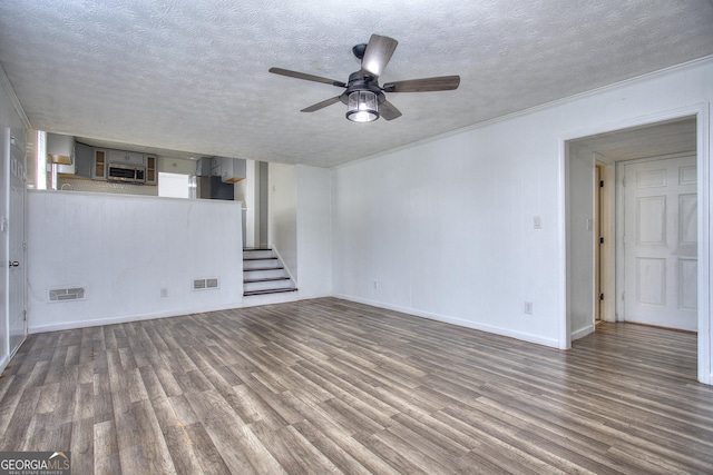 unfurnished living room featuring wood-type flooring, a textured ceiling, and ceiling fan