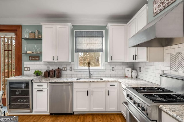 kitchen featuring white cabinets, appliances with stainless steel finishes, wine cooler, and sink