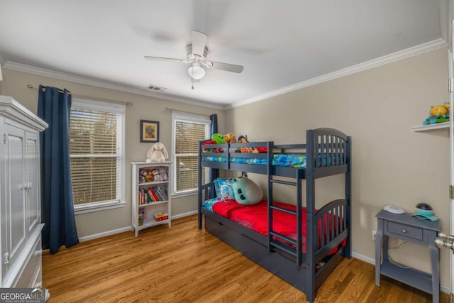 bedroom with ornamental molding, ceiling fan, and hardwood / wood-style flooring