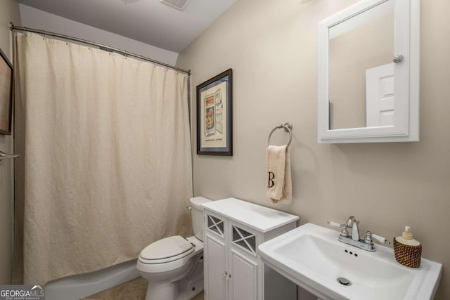 bathroom with sink, toilet, and tile patterned floors