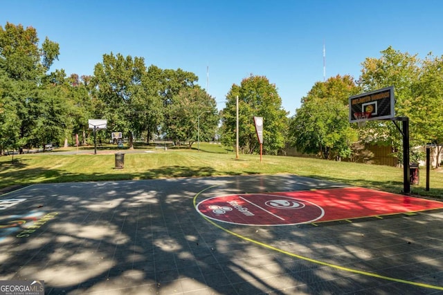 view of sport court featuring a lawn