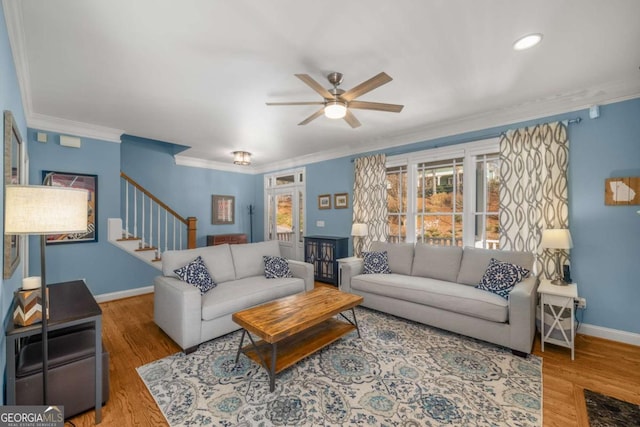 living room featuring ceiling fan, ornamental molding, and hardwood / wood-style flooring