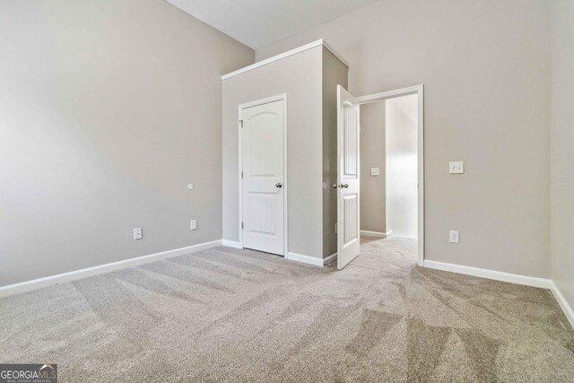 unfurnished bedroom with light colored carpet