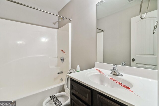 full bathroom featuring toilet, bathing tub / shower combination, and vanity