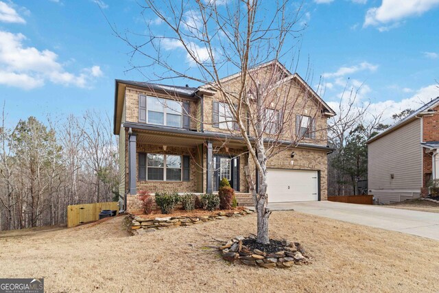 view of property with a garage and covered porch