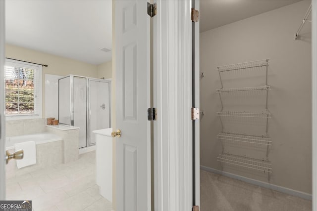 bathroom featuring tile patterned floors and plus walk in shower