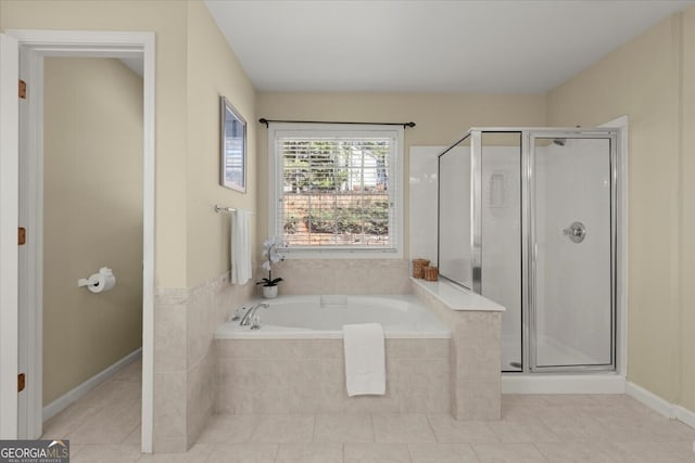 bathroom with tile patterned flooring and separate shower and tub