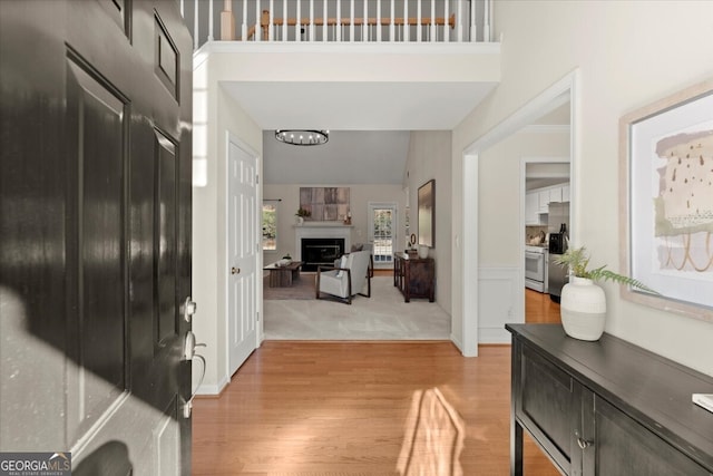 entryway with vaulted ceiling and wood-type flooring