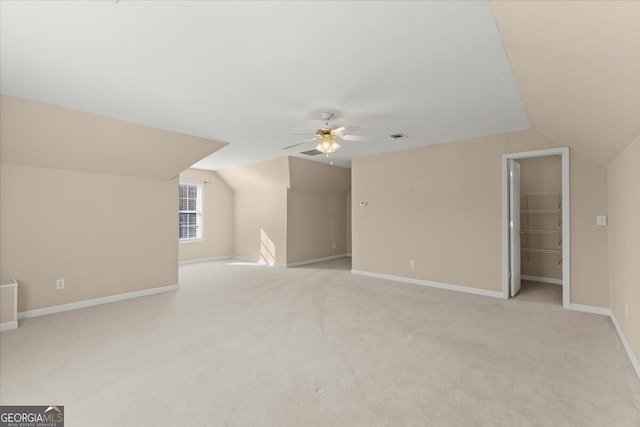 additional living space featuring lofted ceiling, ceiling fan, and light carpet