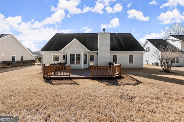 rear view of property with central AC unit and a deck