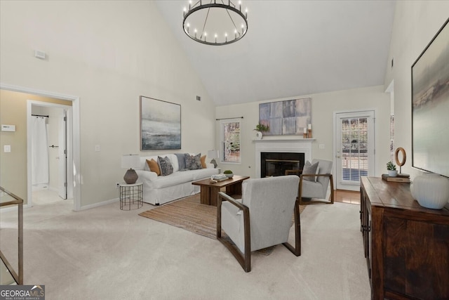 living room with light colored carpet, an inviting chandelier, and high vaulted ceiling