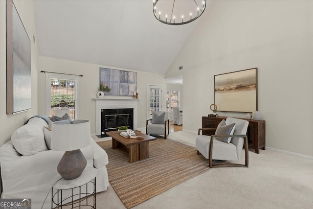 carpeted living room featuring high vaulted ceiling and a notable chandelier