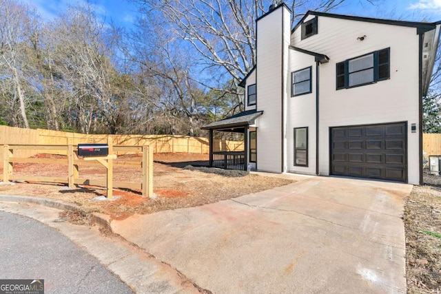 view of property exterior featuring covered porch and a garage