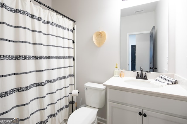 bathroom featuring vanity and toilet