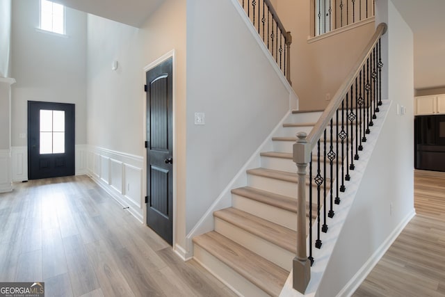 foyer featuring a high ceiling and light hardwood / wood-style floors