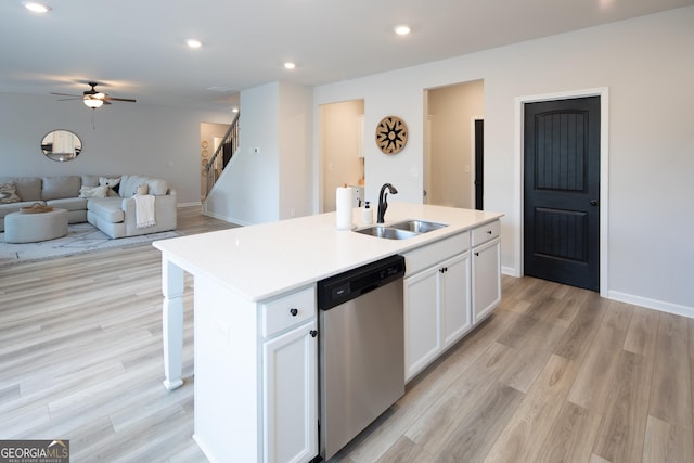 kitchen featuring sink, light hardwood / wood-style flooring, stainless steel dishwasher, a kitchen island with sink, and white cabinets