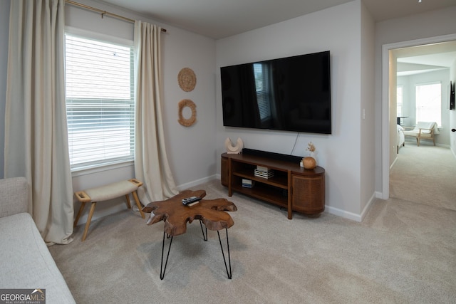 living room featuring light colored carpet and a wealth of natural light