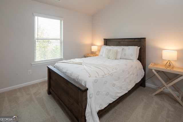 bedroom with vaulted ceiling and carpet floors