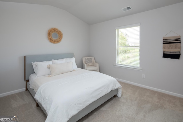 carpeted bedroom with vaulted ceiling