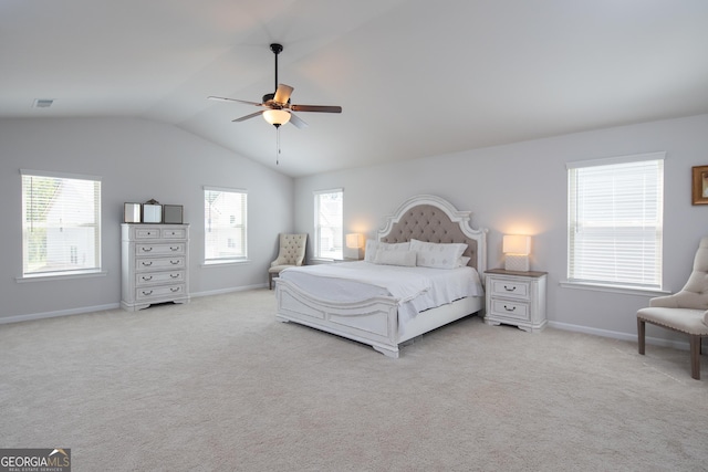 bedroom featuring ceiling fan, vaulted ceiling, and light carpet