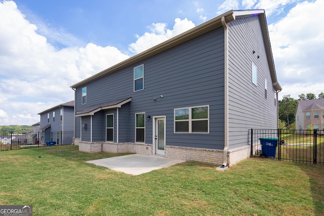 rear view of property featuring a lawn and a patio