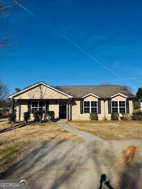 ranch-style house with a front lawn