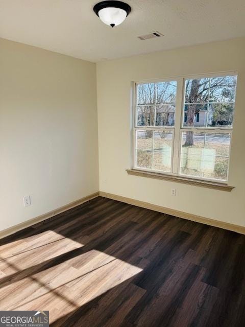 empty room with hardwood / wood-style floors