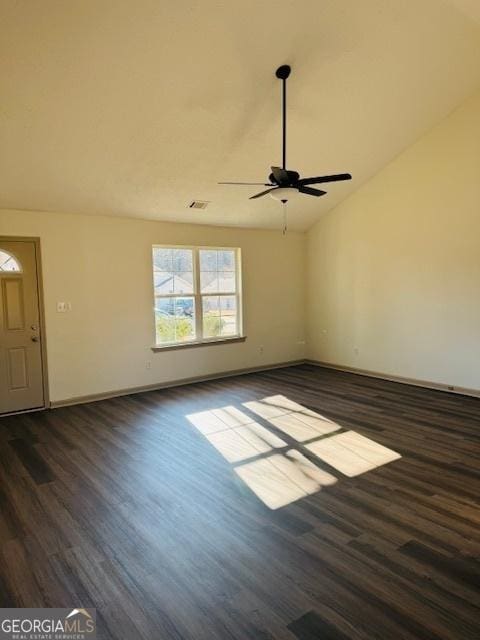 unfurnished room with lofted ceiling, ceiling fan, and dark hardwood / wood-style flooring